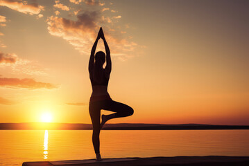 Silhouette of a woman doing yoga