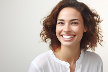 Woman with bright smile holding toothbrush in her mouth. This image can be used to promote dental hygiene or illustrate morning routines.