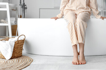 Barefoot woman in bathroom with floor heating