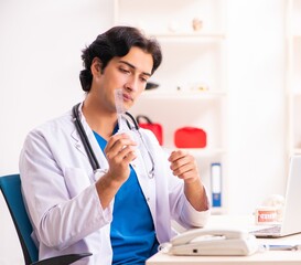 Young male doctor with goniometer