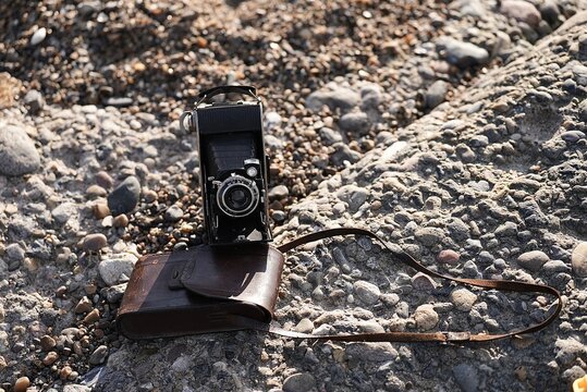 Vintage retro photo, video camera front view lens and logo, Old black retro camera, Vintage folding bellows film camera, Retro camera Agfa on a white background 