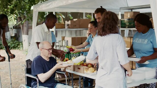 Charitable team offers help to the destitute and distributes free food including fresh fruits to homeless. A wheelchair-bound disabled individual also receives hunger alleviation assistance.