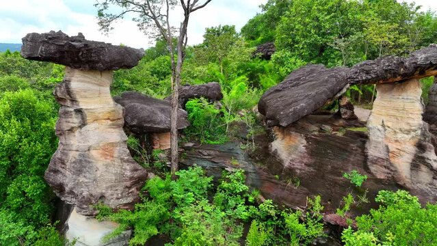 Sao Chaliang in Pha Taem National Park, Thailand, offers stunning aerial views of surreal rock formations, ancient cliff dwellings, and lush landscapes. A must-visit for nature enthusiasts. 4K.
