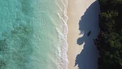 Deurstickers Nungwi Strand, Tanzania Relaxing aerial beach scenery, holiday background. Waves surf with incredible turquoise ocean water, ocean shore, coastline and green forest. Amazing aerial drone top view. Nungwi beach, Zanzibar