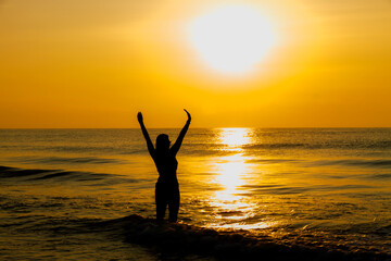 Fototapeta premium Woman body big with bikini and sunrise on beach
