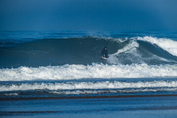 Surfer riding waves in Furadouro Beach