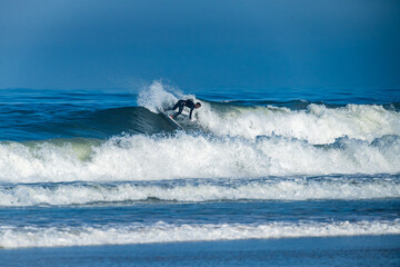Naklejka premium Surfer riding waves in Furadouro Beach