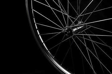 Close-up Bicycle wheel on a black background. Monochrome.