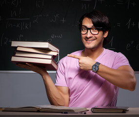 Young male student sitting in classroom