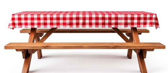 wooden picnic table with benches and red plaid tablecloth on white background