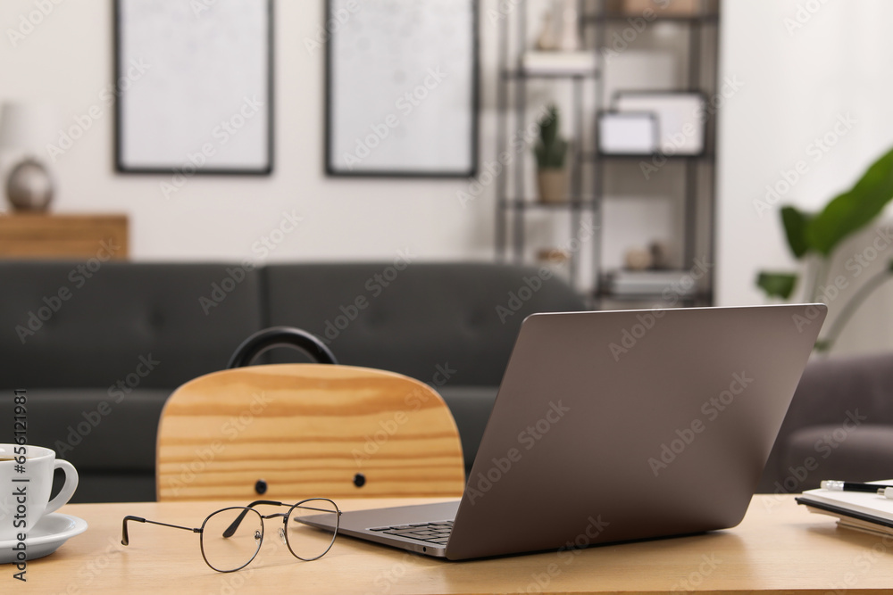 Sticker home workspace. laptop, glasses, cup of coffee and stationery on wooden desk in room. space for text