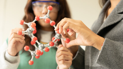 STEM education concept. Asian children in laboratory research an experiment exam with molecule...