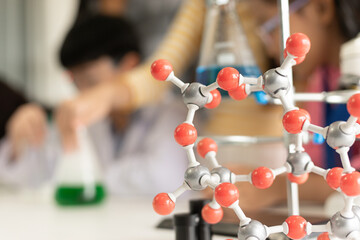 STEM education concept. Asian children in laboratory research an experiment exam with molecule...