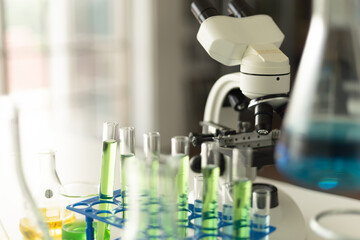 Science equipment in the laboratory. Beaker, test tube, microscope. Children STEM education theme.