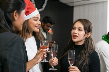 Making a toast, Cheers !! A group of diverse business people and colleagues having fun and meet up together at a business New Year party. A teamwork celebration of a successful business target.