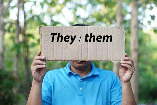 Man hold paper card with words  They  them. Concept, Personal Pronoun words in English. Teaching aid. English grammar, subject and object pronouns. Word card for education. Teaching material. 