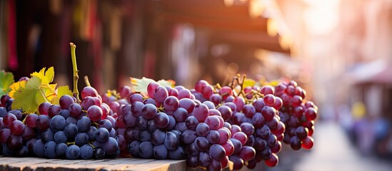 Blurry background frames fresh grapes in traditional market - obrazy, fototapety, plakaty