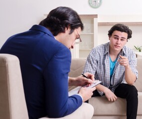 Young male patient discussing with psychologist personal problem