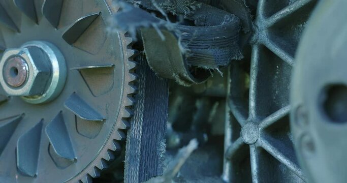 Close-up. Torn damaged variable transmission belt on the scooter.