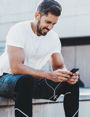 cheerful man in headphones enjoying music song from application