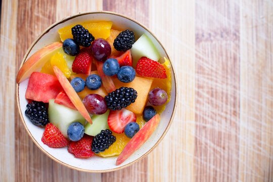 Fresh Fruit Bowl on Wood Cutting Board