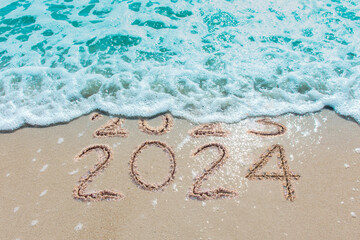 Message Year 2023 replaced by 2024 written on beach sand background. Good bye 2023 hello to 2024 happy New Year coming concept. - obrazy, fototapety, plakaty