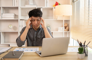 Stressed Young Businessman Facing Financial Loss in Corporate Office, Depressed man Dealing with Financial Setback, Stress and Money Problems, Anxiety and Worry Concept.