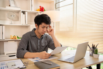 Stressed Young Businessman Facing Financial Loss in Corporate Office, Depressed man Dealing with Financial Setback, Stress and Money Problems, Anxiety and Worry Concept.