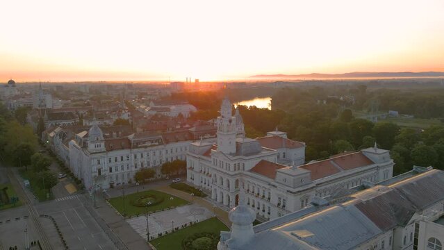 Aerial footage over Arad city center at sunrise, with the Administrative palace in the view. Video was shot from a drone, in the morning, while flying around the building with camera level.