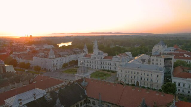 Aerial footage over Arad city center at sunrise, with the Administrative palace in the view. Video was shot from a drone, in the morning, while flying forward with camera level.