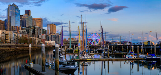 Seattle downtown waterfront buildings, the Great Wheel, and sail boats docked on Puget Sound at...