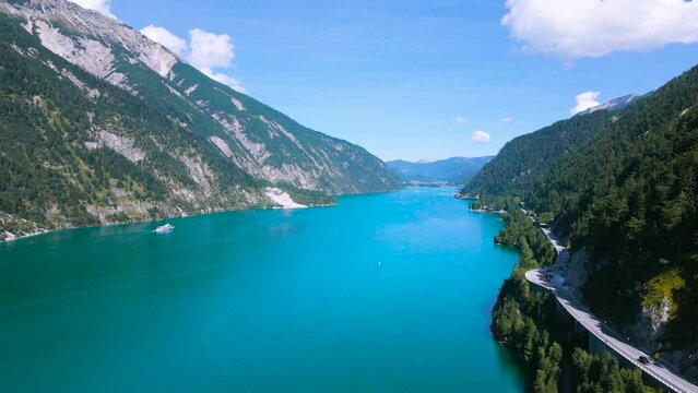Aerial footage of the beautiful Achen Lake in Tyrol, Austria. Video of the lake was shoot from a drone while flying above the lake. In the footage can be seen the lakes blue color and mountains.