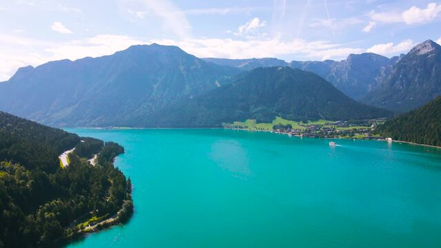 Aerial footage of the beautiful Achen Lake in Tyrol, Austria. Video of the lake was shoot from a drone while flying backwards and picking altitude. In the footage can be seen the lakes blue color.