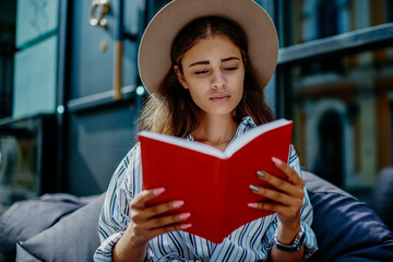 beautiful young woman concentrated on interesting novel bestseller during free time