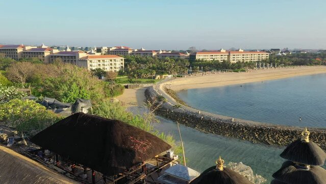 Nusa Dua beach Bali with scenery Hindu Bali temple on top mountain on nature background Bali Indonesia. 4K Aerial UHD Video clip