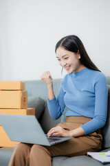 Start a small business Independent Asian woman holding a parcel box Young successful Asian woman with her packaging boxes, online marketing and shipping.