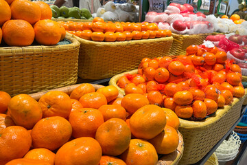 Various type of fresh fruits arrange neatly in grocery store. Apple and Orange on rack.