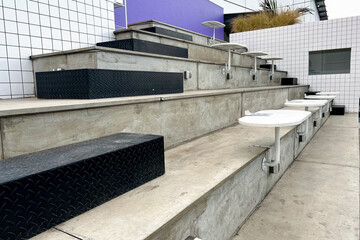 Modern design of coffee shop exterior with chair made from concrete and iron table