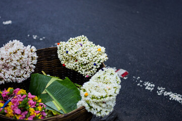 A street side flower merchant selling flowers by the road