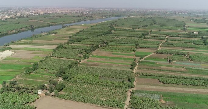 The River Nile of Egypt surrounded by the green lands of the Nile Valley