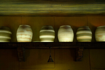 Vintage pottery barrels on a shelf as decoration in a home