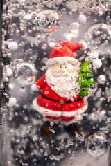 Little Santa Claus in transparent candle wax