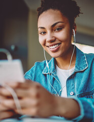 positive hipster girl enjoying music on radio station using mobile app