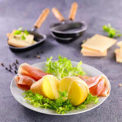 raclette cheese melted on potatoes