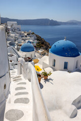  View from viewpoint of Oia village with blue dome of  greek orthodox Christian church. Santorini, Greece