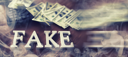 The concept of modern information technology. Fake and facts in the news. The letters spelled the word fake.