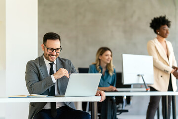 Business men with colleague traders at office monitoring stocks data on screen analyzing price flow