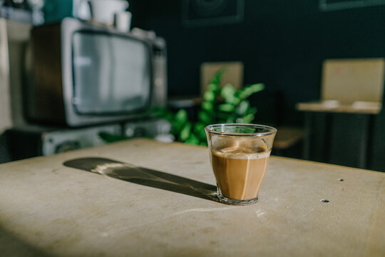 aesthetic perspective view of a cup of coffee in a shop