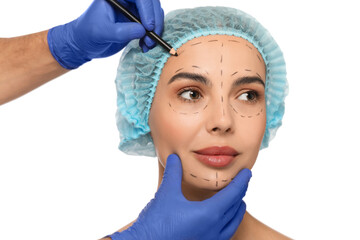 Doctor with pencil preparing patient for cosmetic surgery operation on white background, closeup