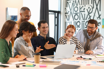 Fototapeta premium Team of employees working together at table in office. Startup project
